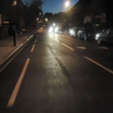 Brightly lit car on a dark night road in London